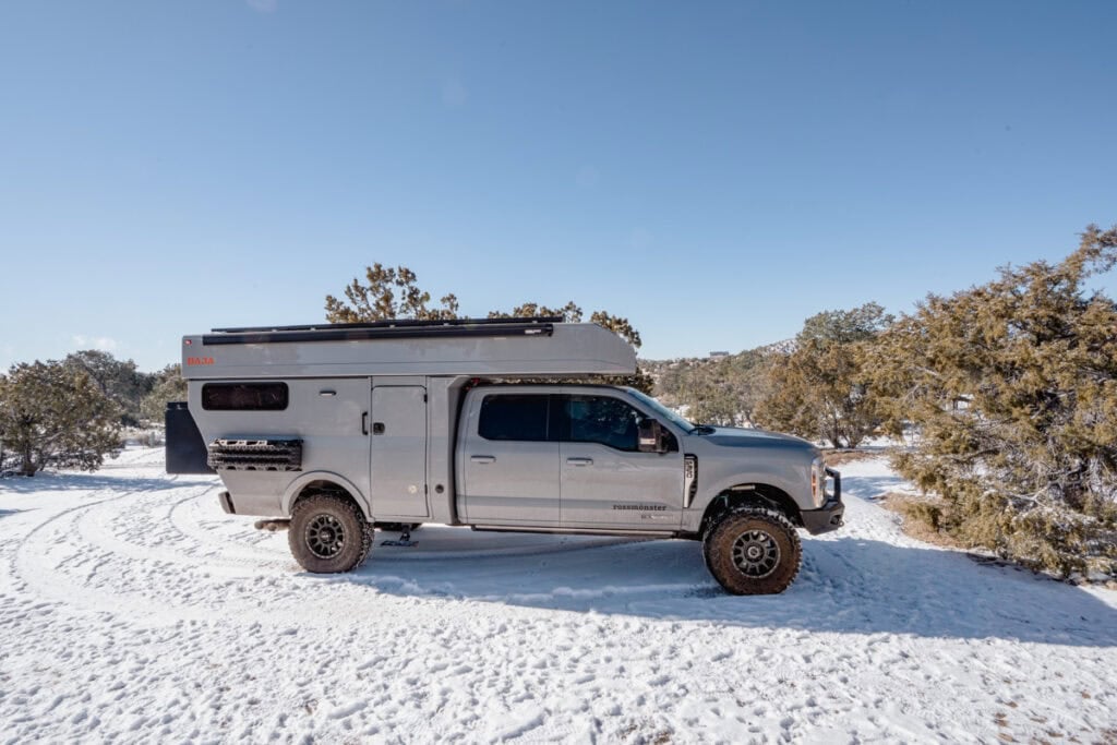 Rossmonster Baja XL truck camper in the snow with Max Trax recovery gear on the side