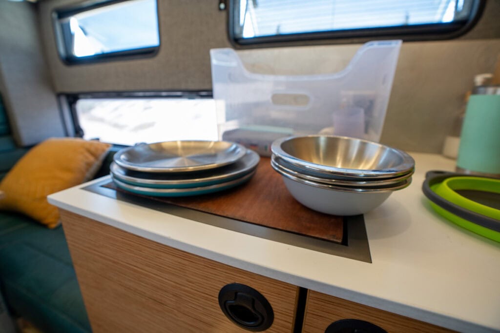plates and bowls on the counter in the Rossmosnter Baja Trail truck camper
