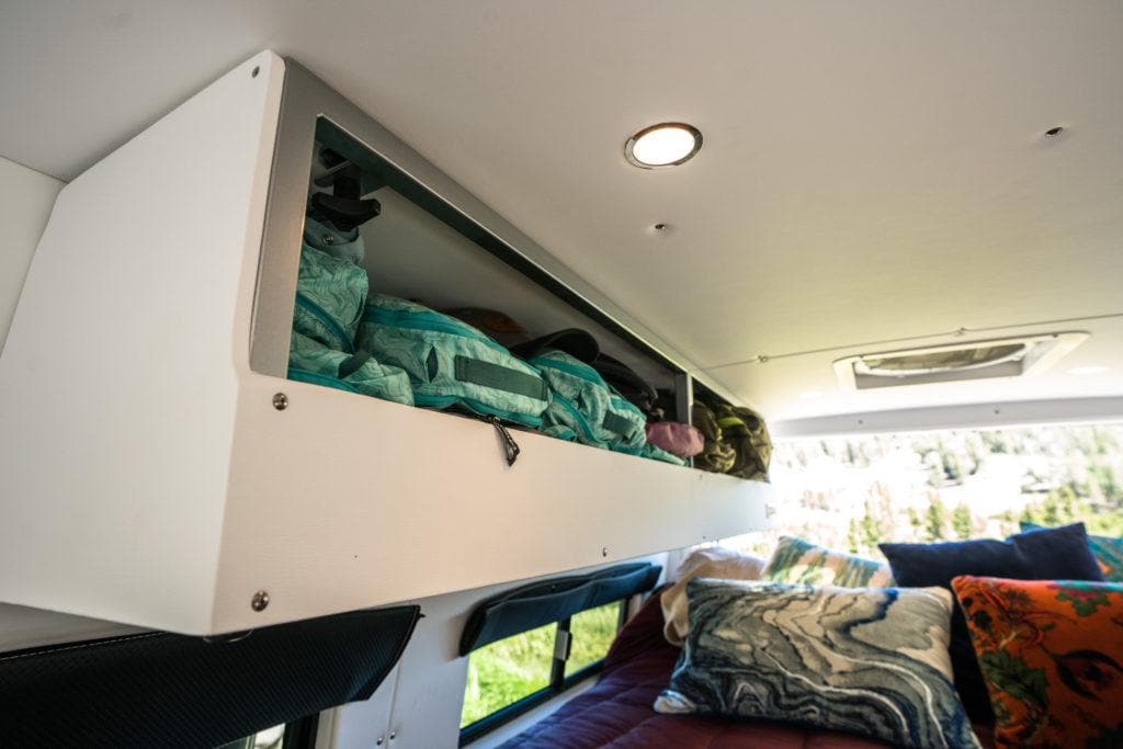 Packing cubes in a cabinet in a Sprinter van