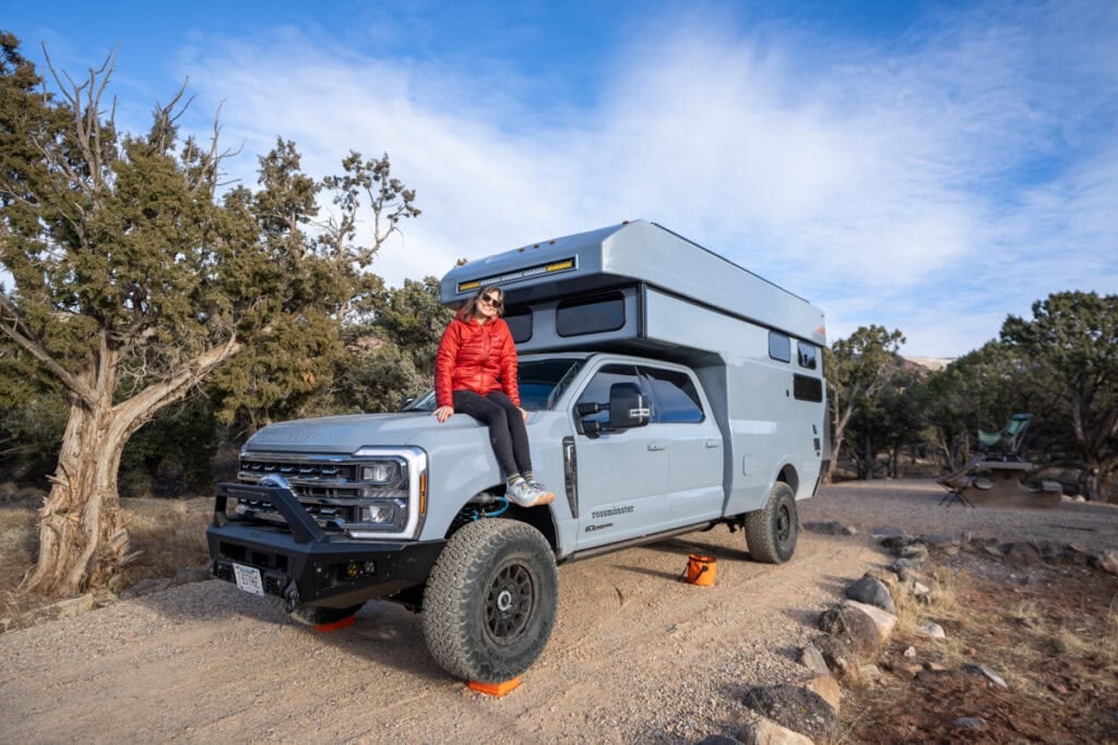 Kristen Bor sitting on the front of the Rossmonster Baja LX Adventure Truck