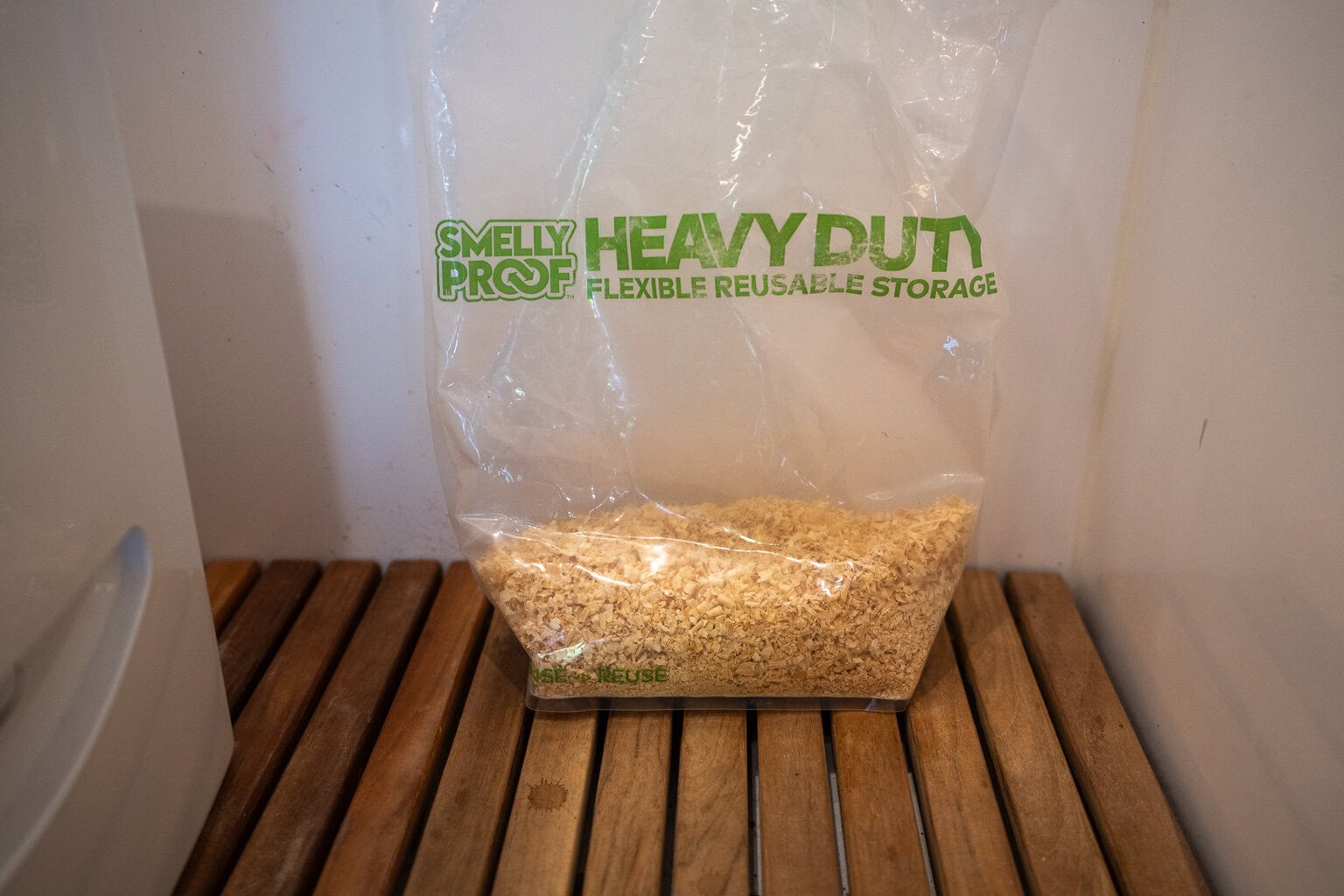 a bag of wood shavings next to the Cuddy Lite toilet